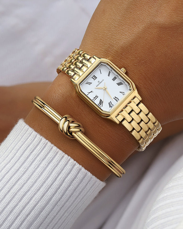 A square womens watch in 22k gold from Waldor & Co. with white Diamond Cut Sapphire Crystal glass dial. Seiko movement. The model is Eternal 22 Bellagio.