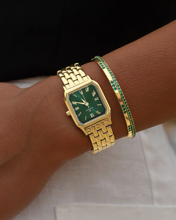A square womens watch in 22k gold from Waldor & Co. with green Diamond Cut Sapphire Crystal glass dial. Seiko movement. The model is Eternal 22 Bellagio.
