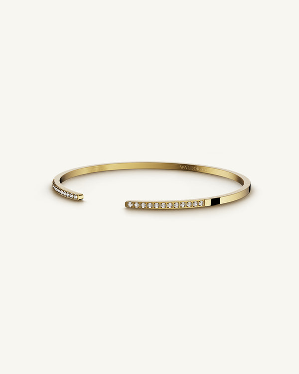 A Bangle in 14k gold plated 316L stainless steel from Waldor & Co. One size. The model is Acme Bangle Polished.
