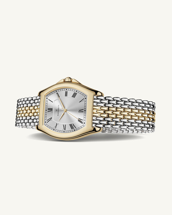 A square womens watch in 22k two-toned silver and gold plated 316L stainless steel from Waldor & Co. with domed mineral glass dial. Seiko movement. The model is Constant 36 Menaggio.