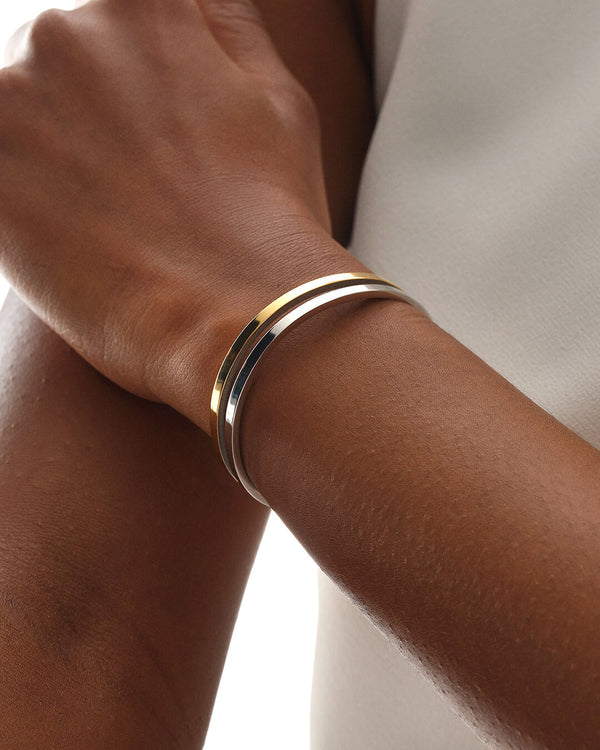 A Bangle in 14k gold plated 316L stainless steel from Waldor & Co. One size. The model is Dual Bangle Polished.
