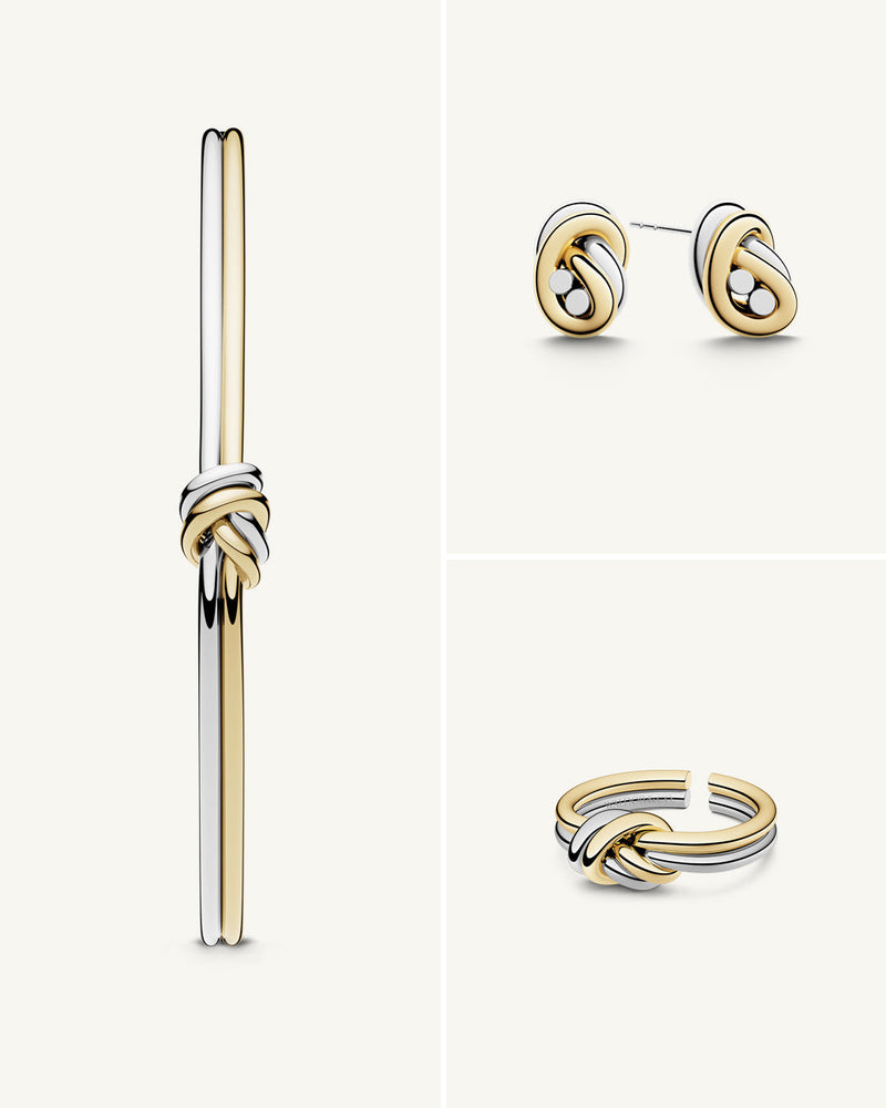 A polished stainless steel jewelry set in 14k gold from Waldor & Co. One size. The model is Dual Knot Ring.