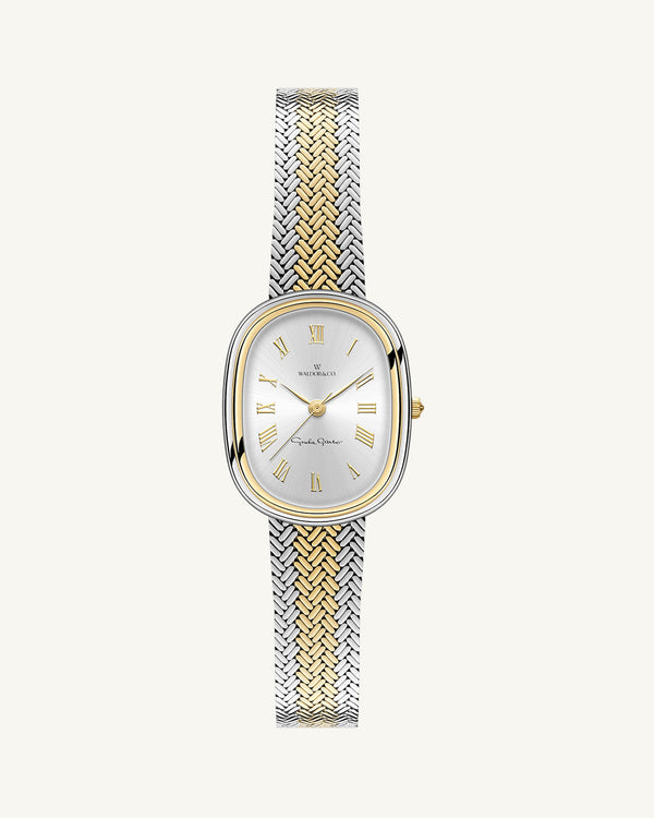 An oval womens watch created under exclusive license from the Greta Garbo™ estate. Featuring a silver sunray dial with gold Roman numerals, framed in a dual-tone case. Seiko movement. 