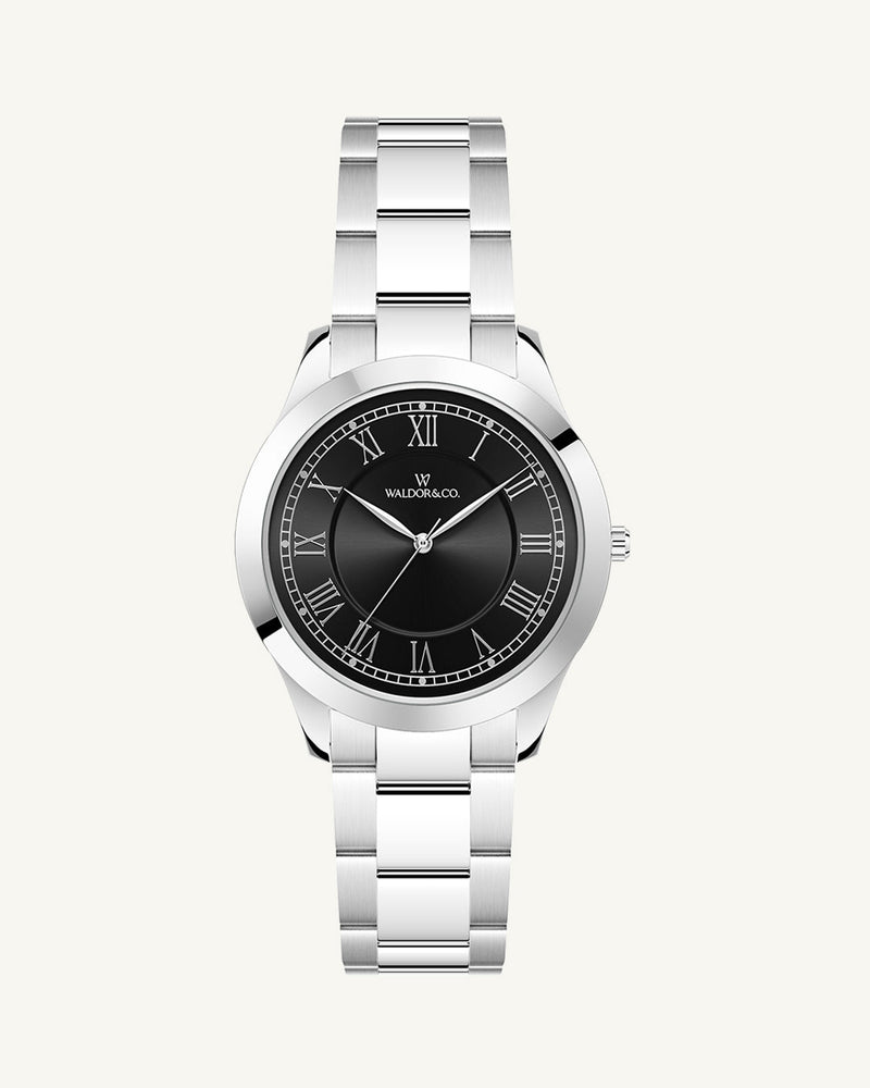 A round womens watch in silver from Waldor & Co. with black sunray dial and a second hand. Seiko movement. The model is Imperial 32 Nocelle 32mm.
