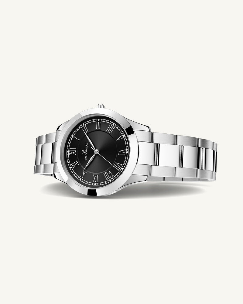 A round womens watch in silver from Waldor & Co. with black sunray dial and a second hand. Seiko movement. The model is Imperial 32 Nocelle 32mm.