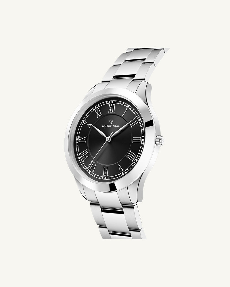 A round womens watch in silver from Waldor & Co. with black sunray dial and a second hand. Seiko movement. The model is Imperial 32 Nocelle 32mm.