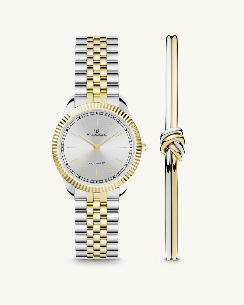 A round womens watch in silver and 22k gold from Waldor & Co. with silver sunray dial and a second hand. Seiko movement. The model is Imperial 32 Positano 32mm