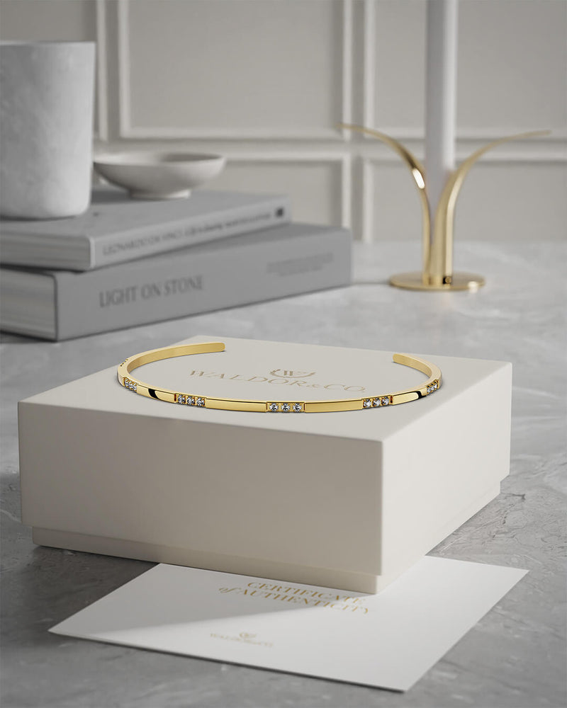 A Bangle in 14k gold-plated 316L stainless steel from Waldor & Co. One size. The model is Opulent Bangle Polished.A Bangle in 14k gold-plated 316L stainless steel from Waldor & Co. One size. The model is Opulent Bangle Polished.