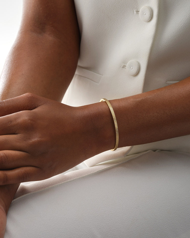 A Bangle in 14k gold plated 316L stainless steel from Waldor & Co. One size. The model is Pavé Bangle Polished.