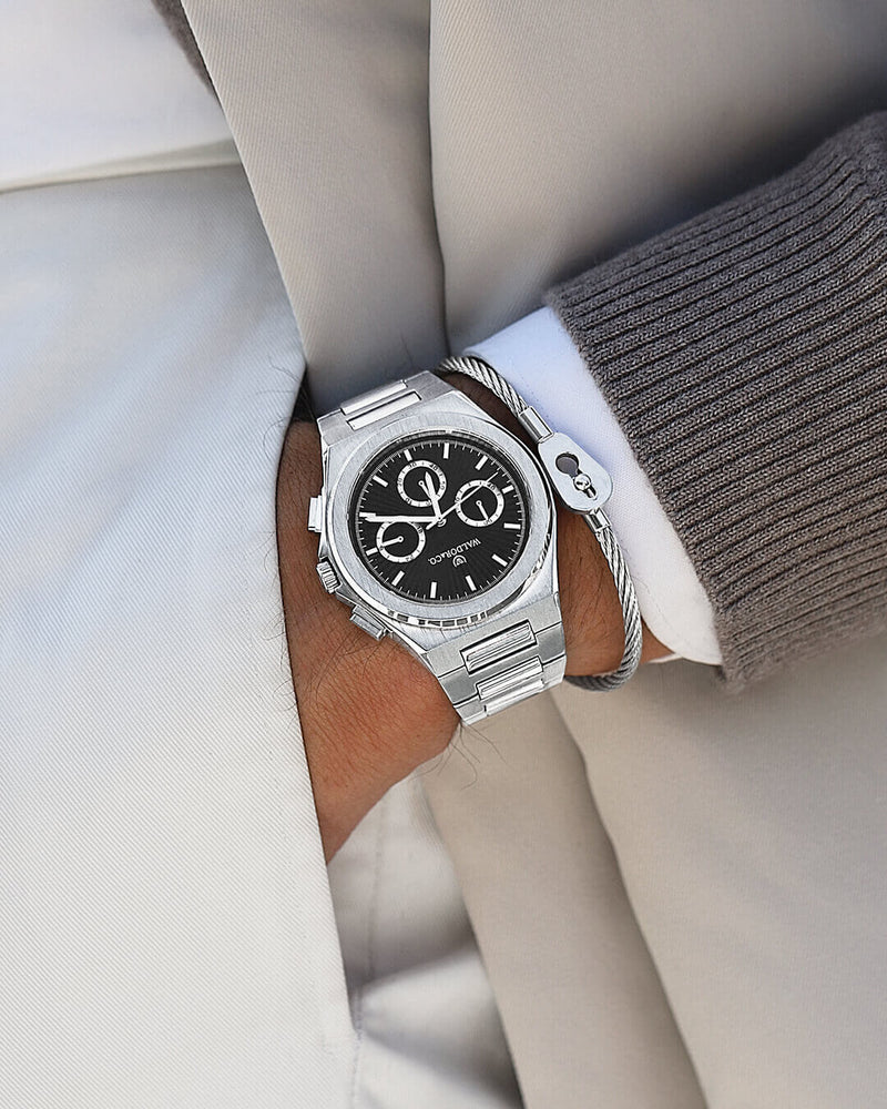 A round mens watch in rhodium-plated silver from Waldor & Co. with black sunray dial and luminous hands. Seiko movement. The model is Inceptive 40 Azores.