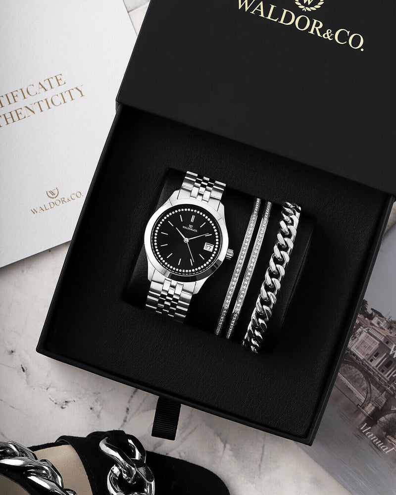 A round womens watch in Rhodium-plated 316L stainless steel from Waldor & Co. with black sunray dial and a second hand. Seiko movement. The model is Imperial 36 Roma 36mm.