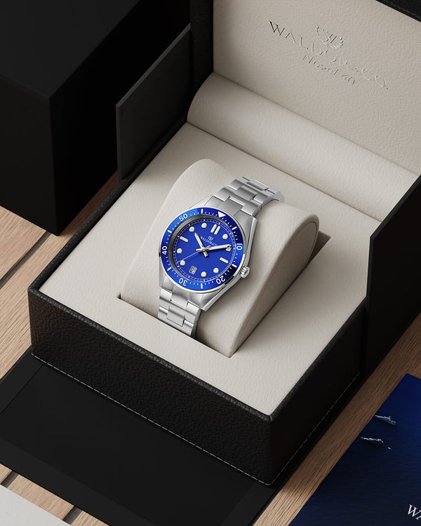 lifestyle_image,A round mens watch in Rhodium-plated 316L stainless steel from Waldor & Co. with Blue dial in brass with a rotating bezel. Applied indices, luminous hands. Ronda 715. The model is Novel 40 Cap d’Ail 40mm