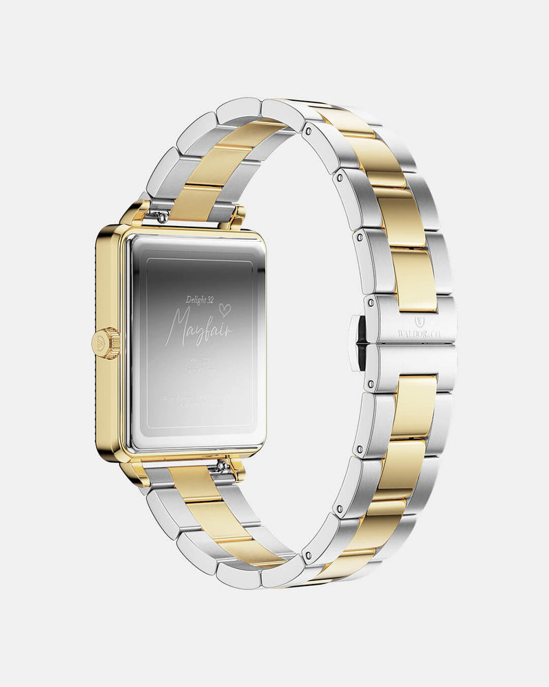 A square womens watch in 22k gold-plated 316L stainless steel with stones from WALDOR & CO. with black sunray dial and a second hand. Seiko VJ22 movement. The model is Delight 32 Mayfair Ltd. Edition 28x32mm. 