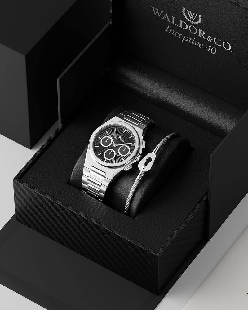 A round mens watch in rhodium-plated silver from Waldor & Co. with black sunray dial and luminous hands. Seiko movement. The model is Inceptive 40 Azores.